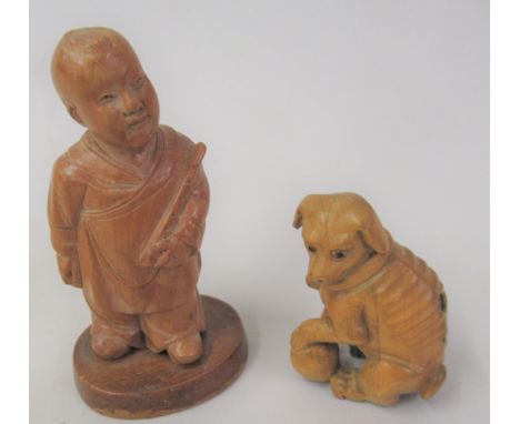 Chinese carved boxwood netsuke in the form of a seated dog, together with a carved boxwood figure of a boy 