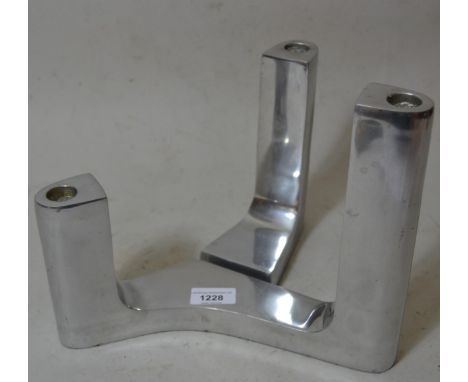 Polished aluminium twin light candlestick of asymmetric abstract form, 10.5ins x 9ins together with another smaller 