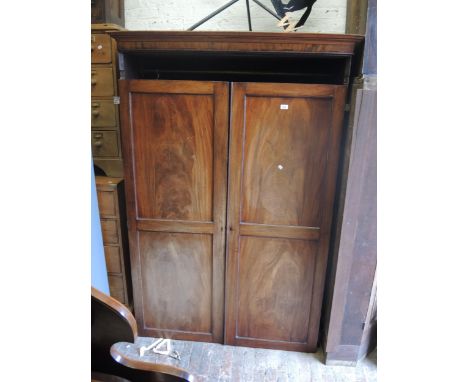 19th Century mahogany wardrobe, the moulded cornice above two panel doors enclosing hanging space, on bracket feet, 51ins wid