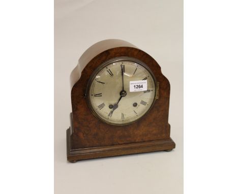 Early 20th Century figured walnut mantel clock with a silvered dial, Roman numerals and two train movement 