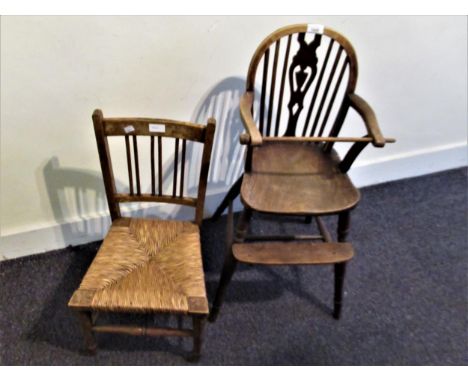 19th Century child's Windsor high chair with a pierced vase and stickback above a carved panel seat, turned supports, stretch