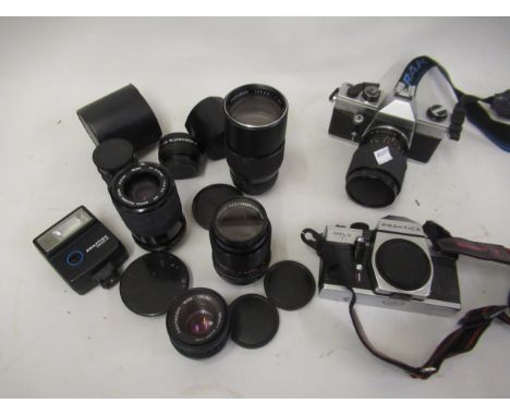 Two Praktica camera bodies, together with a quantity of various camera lenses 