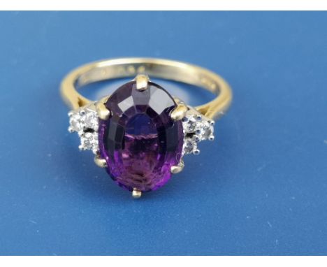 A modern amethyst &amp; diamond set 18ct gold ring.  Finger size K.