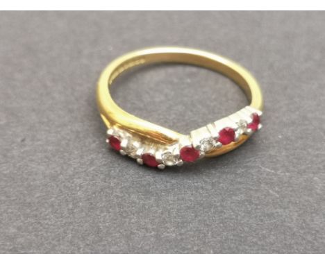 A modern 18ct gold ring set with 9 small rubies and diamonds, of twisted design - Birmingham marks.  Finger size N.