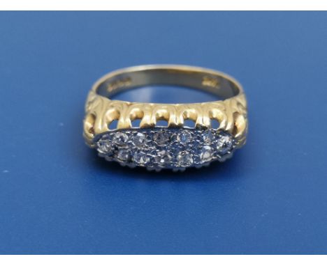 An 18ct gold ring set with two rows of small diamonds - London hallmarks.  Finger size O/P.