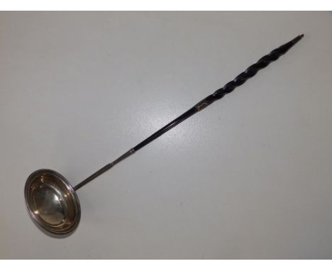 A Georgian toddy ladle with twisted whalebone handle, 16" - repair to handle joint.