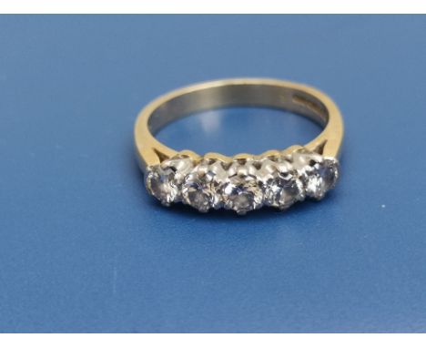 A five stone diamond ring, each stone of approximately 3mm diameter on 18ct gold shank.  Finger size L.