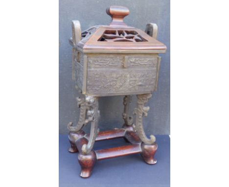 An antique Chinese archaistic bronze rectangular censer, on four scroll cast feet, pierced wooden cover with upturned handles