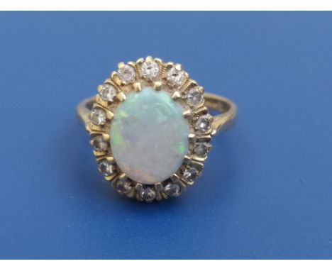 An opal &amp; diamond set 18ct gold oval cluster ring - Birmingham hallmarks.  Finger size L.