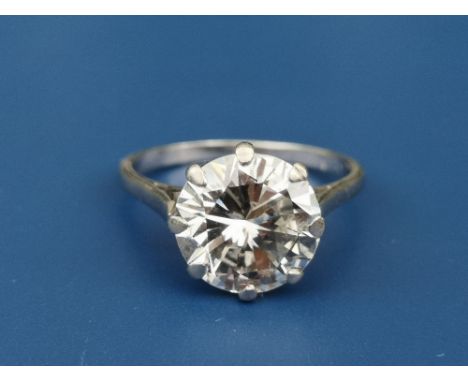 A diamond solitaire ring, the claw set brilliant weighing approximately 4 carats, on white metal shank.  Finger size O.