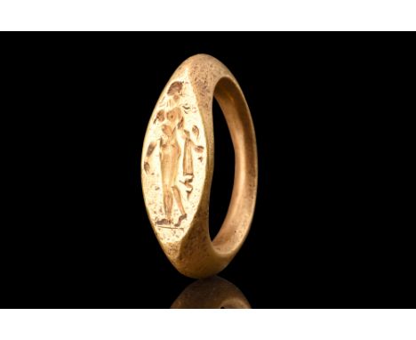 Ca. 400 BC.A gold ring adorned with a depiction of the standing nude Aphrodites. This enchanting representation showcases the