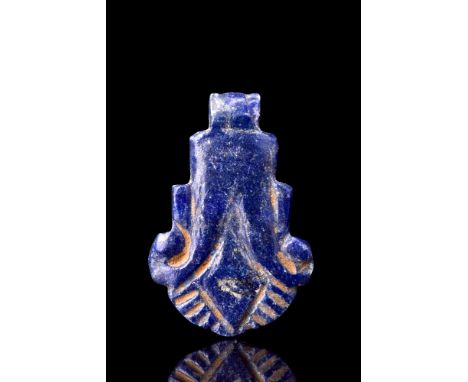 Ca. 1070-664 BC.An exquisite lapis lazuli amulet modelled in the shape of a blossoming palmette, likely a lotus flower. The p