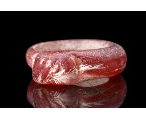 Ca. 300 AD.A glass finger ring characterized by its deep red colour. The ring features a round hoop, delicately crafted from 