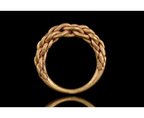 Ca. 900–1000 AD. Viking Age. .A twisted ring made by interweaving four circular golden hoops coming together at the ring’s ba