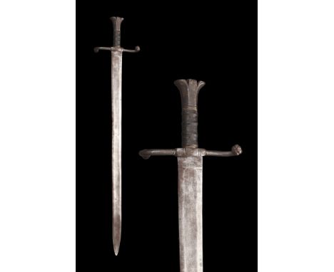 Ca. 1400-1500 AD.An iron sword comprising of a broad triangular blade with rounded tip and fuller to the upper third of each 