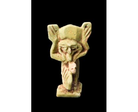 Ca. 664-332 BC.An amulet made of apple green faience of the air god Shu. He is depicted kneeling, with one knee to the ground