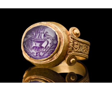 Ca. 200-300 AD.An amethyst intaglio, housed within a gold ring, presents a captivating engraving that unfolds a visually comp