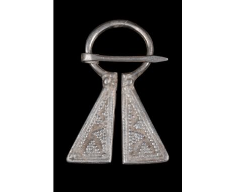 Medieval Western Europe, ca. 1100-1400 AD.A Viking-inspired, silver omega penannular brooch featuring flanges with panels emb