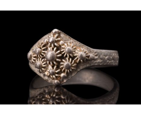 Ca. 600-800 AD.A silver ring boasting a flat-section shank, providing a comfortable fit for the wearer. The exterior face of 