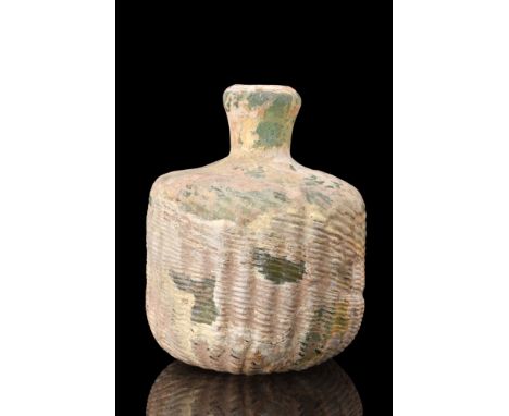 Ca. 300-500 AD.A glass flask showcases a globular body with a distinctive concave base. The entire body of the flask is adorn