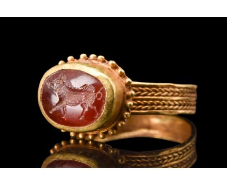 Ca. 100-200 AD.A high quality garnet intaglio presents a captivating portrayal of a right-facing wild boar captured in mid-st