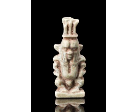Ca. 664-332 BC.A composition amulet of the dwarf god Bes in light faience. Modelled in a stylised grotesque manner, with a gr