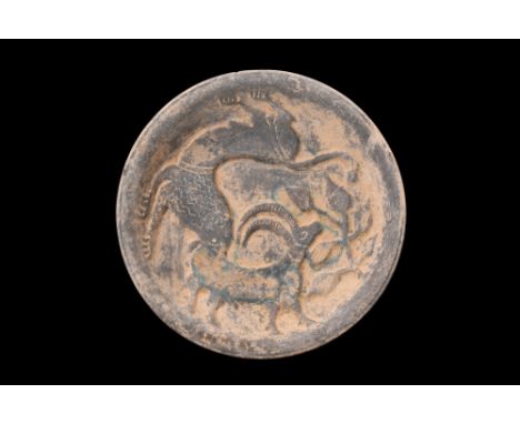Undated.A circular-shaped plate, crafted from schist, a metamorphic rock known for its durability and fine-grained texture, t