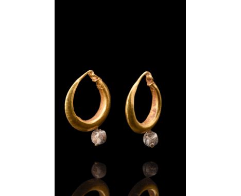 Ca. 323-31 BC.A remarkable representation of the exquisite craftsmanship of Hellenistic gold jewelry, this matched pair of ea
