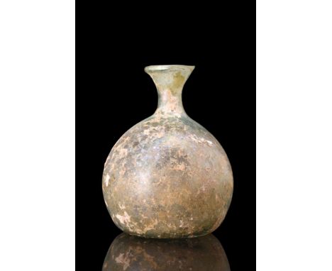 Ca. 100-300 AD.A free-blown glass flask featuring a squat, bulbous body on a concave base with a pontil scar, a short cylindr