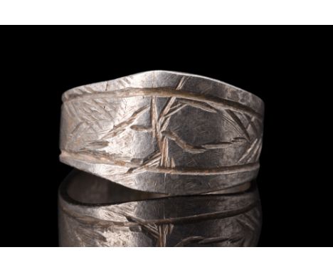 Ca. 900-1100 AD.Crafted from silver, this ring features a flat-section round band with a slight expansion, resulting in a com