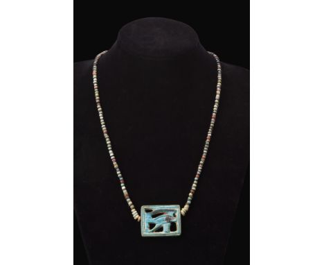 Late Period, ca. 664-332 BC.A multi-coloured faience pendant necklace centred with a superior Eye of Horus faience amulet. Wa