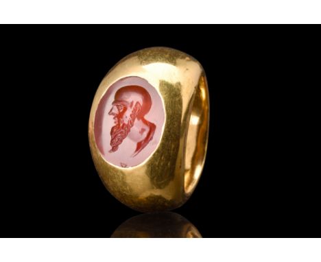 Ca. 100-300 AD.A high carat gold ring set with carnelian intaglio with a captivating depiction of a philosopher, possibly Soc