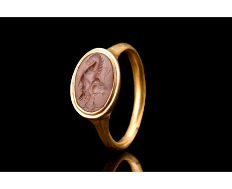 Ca. 100-300 AD.A fine gold finger ring of a round-section hoop expanding to form an oval bezel set with a jasper intaglio eng