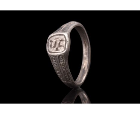 Ca. 900-1100 AD.A silver ring featuring a flat-section shank, which gradually expands to form a square-shaped bezel. The shou