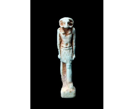 Ca. 664-332 BC.An Egyptian faience amulet of the god, Khnum. He is depicted striding forward, with arms by his side and his f