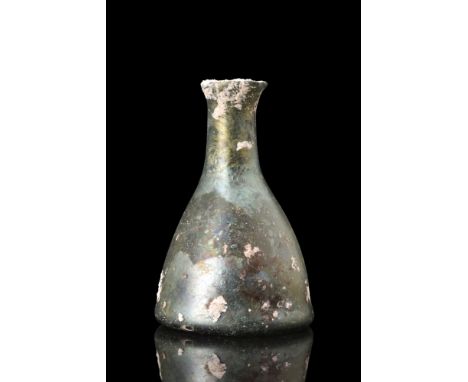 Ca. 100-300 AD.A glass flask showcases a bell-shaped lower body, a short tubular neck with a rounded rim, and a concave base 