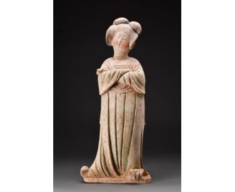 Ca. 618-907 AD.A ceramic tomb statue known as the 'Fat Lady.' This standing figure, facing forward with one foot slightly ang