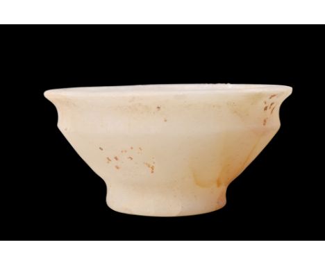 New Kingdom, ca. 1550-1070 BC.An alabaster bowl featuring smooth walls that gracefully curve into an everted rim and a rounde