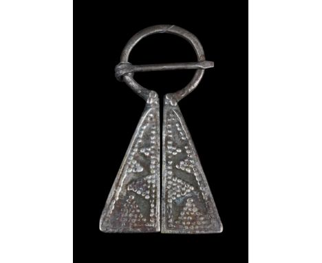 Medieval Western Europe, ca. 1100-1400 AD.A Viking-inspired, silver omega penannular brooch featuring flanges with panels emb