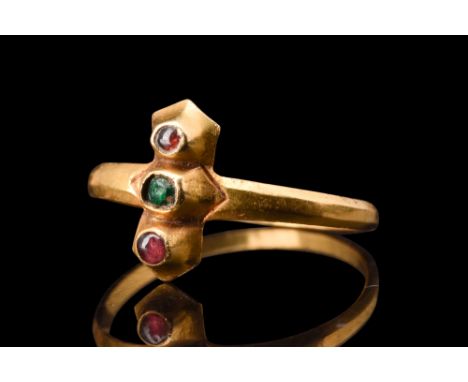 Ca. 1200-1300 AD.A gold ring characterized by its elegant and delicate construction, enriched by three gemstones original to 