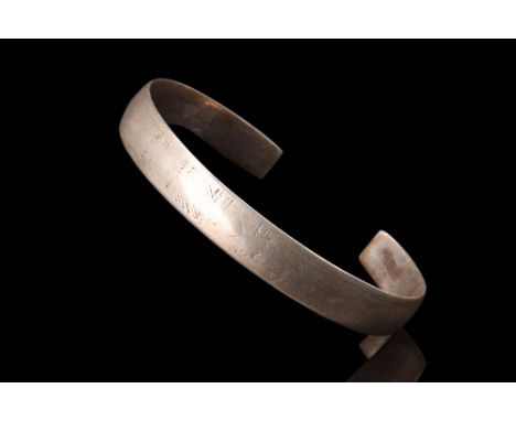 Ca. 100-300 AD.A silver bracelet showcases an elegant design characterized by its open type. The flat-section shank, meticulo