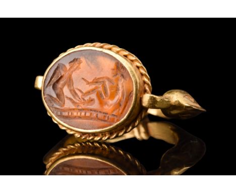 Ca. 100-300 AD.A carnelian intaglio, set within a potentially later gold finger ring, presents a remarkable depiction of a ch