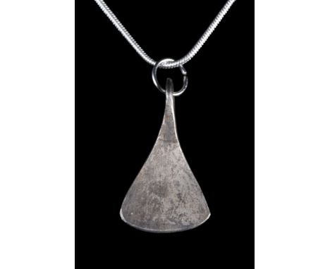 Northern Europe, ca. 700-900 AD.A silver pendant with an integral loop shaped like a Viking axe head. Good condition. This ty