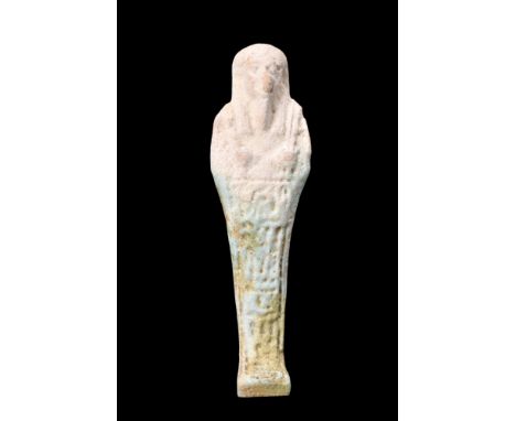 Late Period, Ca. 664-332 BC.A light faience ushabti. This mummiform figurine stands atop a diminutive, level base, with its h