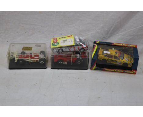 Four slot cars featuring boxed/cased Scalextric C2000 Opel Vectra (damage to box), Ferrari 312T (broken spoiler), McLaren M23