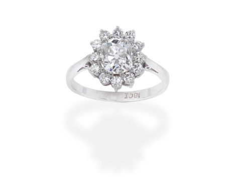DIAMOND CLUSTER RINGThe cushion-shaped diamond, weighing 1.87 carats, within a brilliant-cut diamond surround, remaining diam