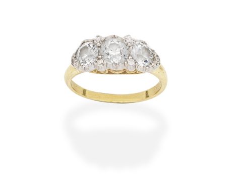 DIAMOND THREE-STONE RINGSet with three cushion-shaped diamonds with similarly-cut diamond accents, within pinched collet sett