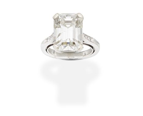 DIAMOND SINGLE-STONE RINGSet with a step-cut diamond, weighing 7.01 carats, between brilliant-cut diamond shoulders, ring siz
