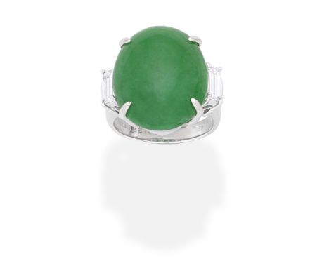 JADE AND DIAMOND RINGThe oval jadeite jade cabochon set between baguette-cut diamond shoulders, diamonds approx. 0.50ct total