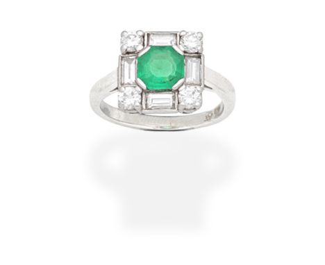 EMERALD AND DIAMOND RINGThe octagonal step-cut emerald set within a brilliant and baguette-cut diamond surround, ring size ap